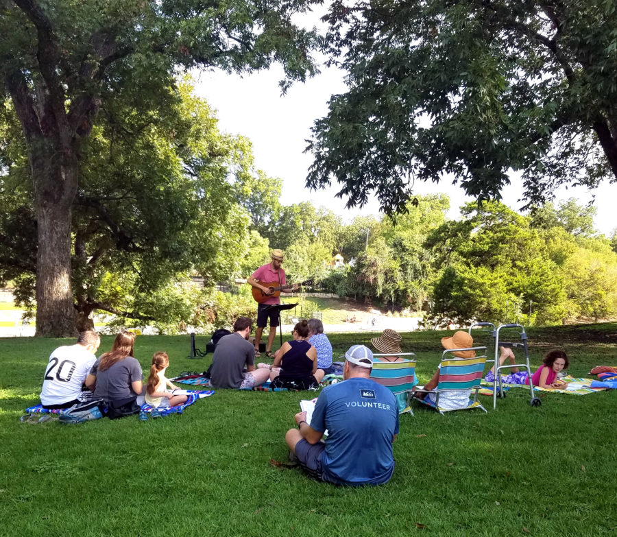 J leading singalong group w Barton Springs behind